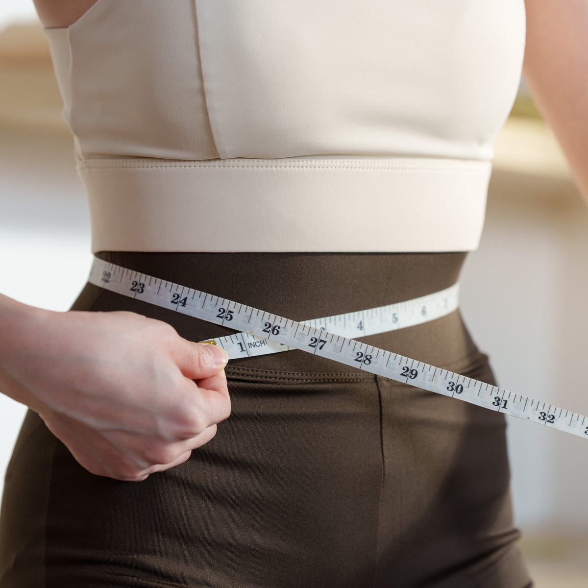 A tape measure drawn around a person's waist
